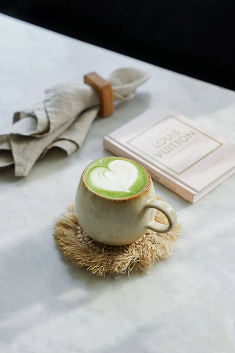 Serviettenring 'Teak Root' rond servet bij tas met matcha