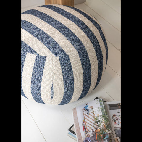 J-Line Striped poef in blauw en off-white op een witte houten vloer met magazines